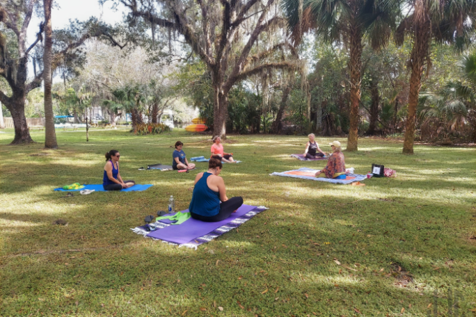 a group of people sitting at a park